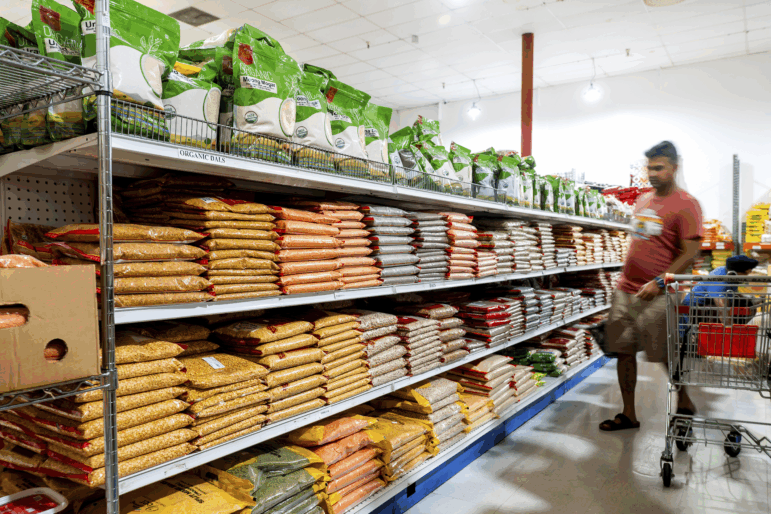 A customer shops a grain isle at New India Bazar, where most merchandise is imported from India and Canada, on Aug. 6, 2025, in Fremont, Calif.