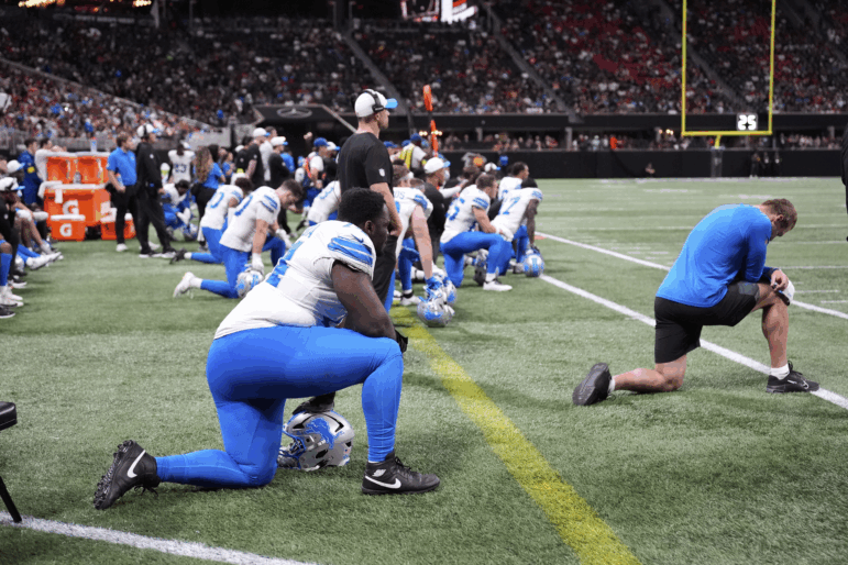 Detroit Lions players take a knee after safety Morice Norris was injured against the Atlanta Falcons during the second half of an NFL preseason football game on Friday in Atlanta.