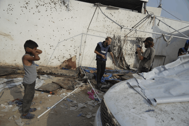 Palestinians inspect on Monday, Aug. 11, 2025, the destroyed tent where journalists, including Al Jazeera correspondents Anas al-Sharif and Mohamed Qureiqa were killed by an Israeli airstrike outside the Gaza City's Shifa hospital complex.