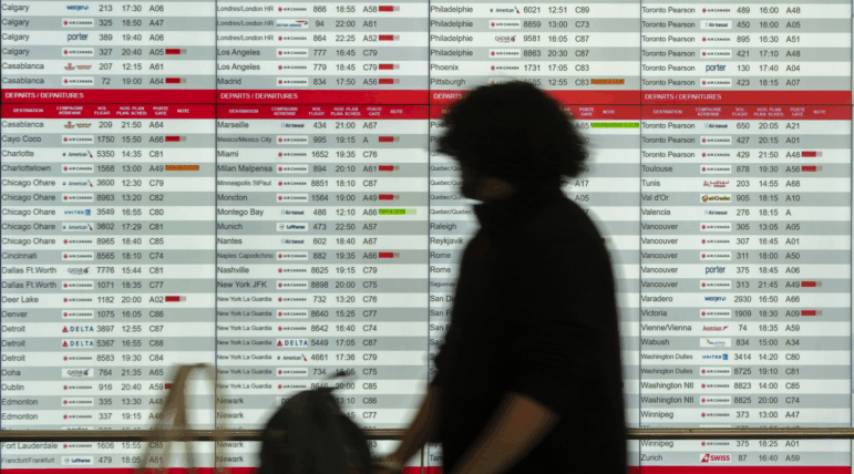 Cancelled and delayed Air Canada flights are seen on the departure board at Montreal-Pierre Elliott Trudeau International Airport on Friday.