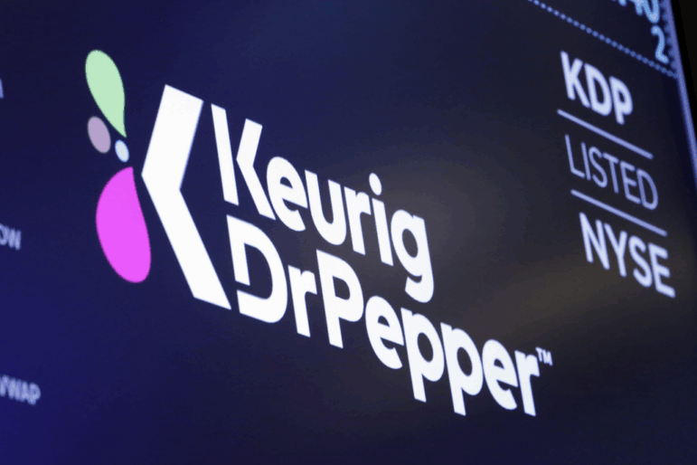 The logo for Keurig Dr. Pepper appears in July 2018 above a trading post on the floor of the New York Stock Exchange.