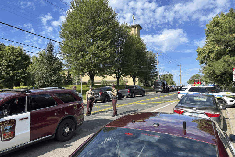Law enforcement officers gather outside the Annunciation Church's school in response to a reported mass shooting on Wednesday in Minneapolis.