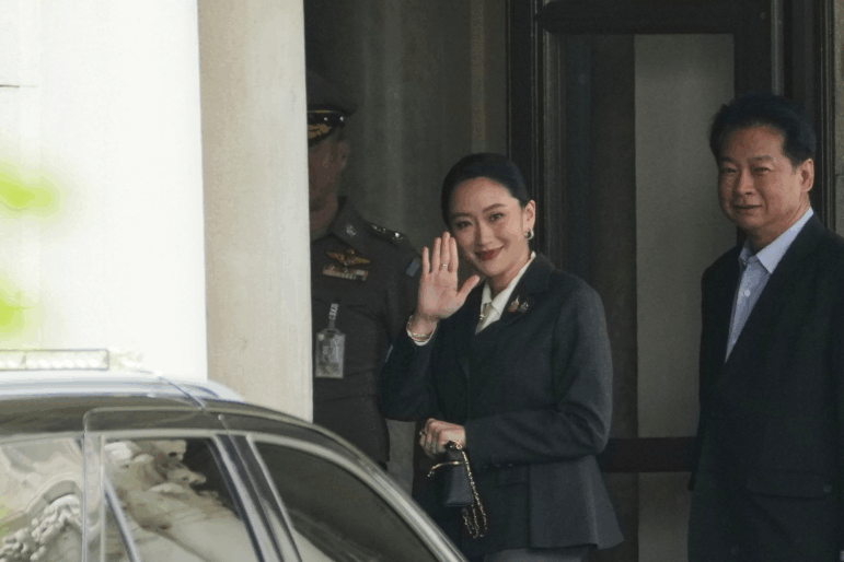 Thailand's suspended Prime Minister Paetongtarn Shinawatra, center, arrives at Government House in Bangkok, Thailand, Friday, Aug. 29, 2025.