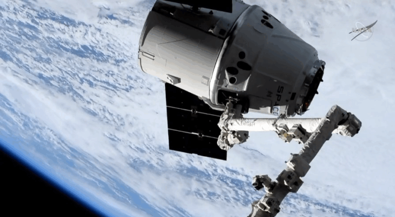A robotic arm attached to the International Space Station brings in the spacecraft carrying one of the two Orbiting Carbon Observatory instruments, known as OCO-3, in 2019. NASA has put out a call for private groups to potentially take over the cost of maintaining the instrument, which measures carbon dioxide in the Earth's atmosphere.