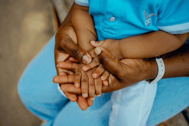 African mother's hand and African child's hand close-up