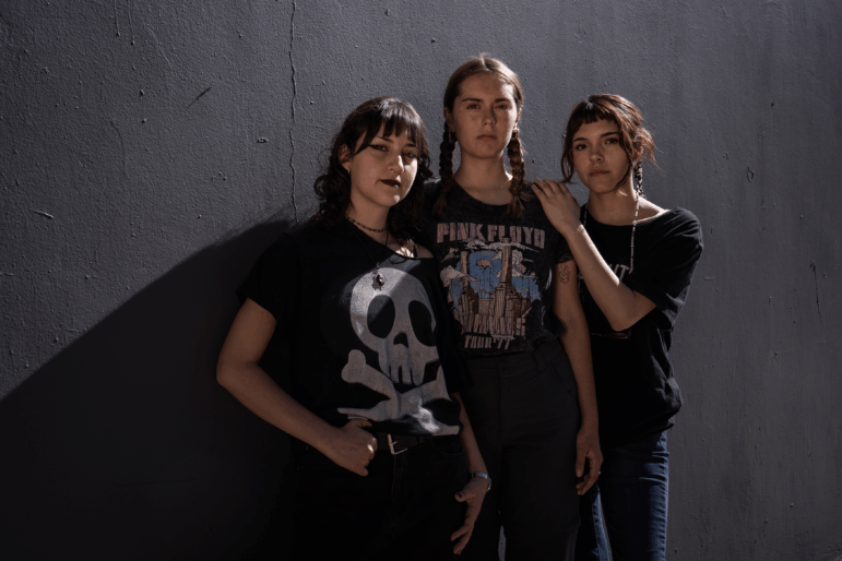 Macarena Lagos, 18, F. Contreras, 21, and Mariana Sanhueza Weish, 22, are design students at the Catholic University in Santiago. All three voice strong reservations about having children. Their reasons vary: one doesn’t believe she would make a good mother, others want to pursue creative careers, and some feel the world is not a good place to raise children. Santiago, Chile, on Saturday, May. 10, 2025 / Tamara Merino for NPR.