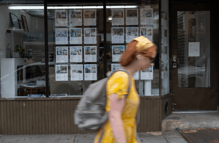 Ads for rental apartments are posted on the window of a real estate agent's office in Brooklyn, New York, during the summer of 2022.