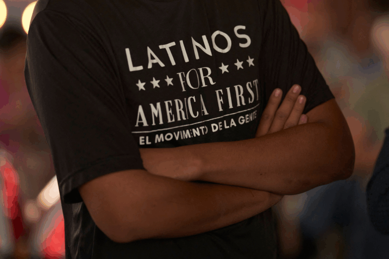 In this file photo from 2022, a man wearing a "Latinos for America" t-shirt attends a campaign event for Republican Congressional candidates at University Drafthouse in Mcallen, Texas.