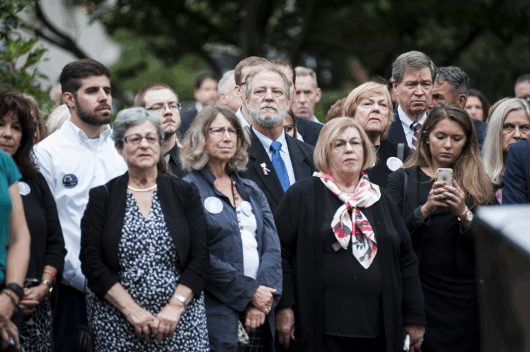Michael Keating, center in the second row, stood during the wreath laying at the 9/11 memorial at the Boston Public Garden on September 11, 2016. His mother, Barbara Ann Keating, was killed during the September 11th attacks in 2001.  Her remains have now been identified in New York City according to local officials.