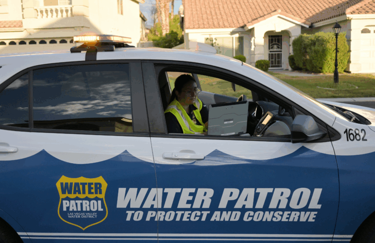 Las Vegas Valley Water District Water Waste Investigator Devyn Choltko puts a water waste violation into the computer system outside a home in North Las Vegas, Nevada, on June 25, 2024. Choltko looks for water being wasted during irrigation times outside residential homes. She said most of the time she leaves a warning flag if she finds something wrong for residents to fix, but if the problem is not fixed and Water Waste Investigators record the violation again, it will most likely result in a fine for the property owner. (Photo by RJ Sangosti/MediaNews Group/The Denver Post via Getty Images)