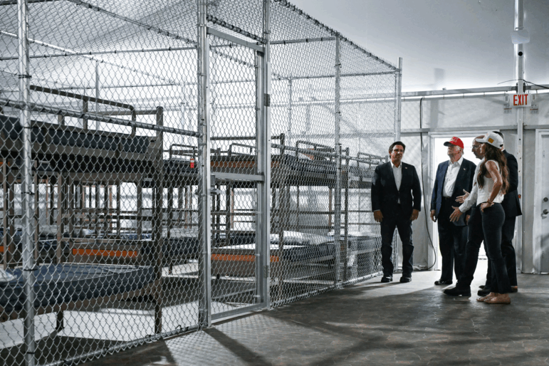 President President Donald Trump (second from left), Florida Governor Ron DeSantis (L), and Secretary of Homeland Security Kristi Noem (R) tour a migrant detention center, dubbed "Alligator Alcatraz," located at the site of the Dade-Collier Training and Transition Airport in Ochopee, Fla. on July 1, 2025.