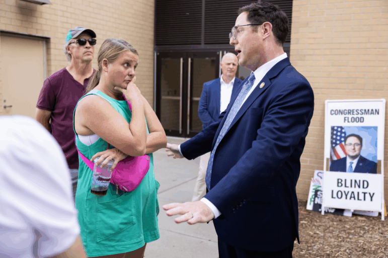 Karen Wagner, left, speaks with Rep. Mike Flood before a town hall at Kimball Recital Hall on campus at the University of Nebraska Lincoln in Lincoln, Nebraska, on August 4, 2025.