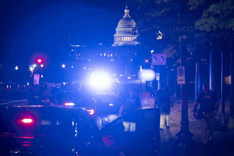 Members of the FBI and D.C.'s Metropolitan Police Department conduct a traffic stop near the U.S. Capitol in Washington, D.C., on August 14.