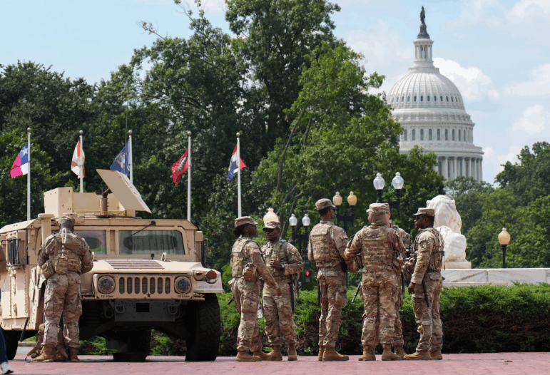 Members of the National Guard stand near D.C.'s Union Station, within view of the U.S. Capitol, on Thursday.