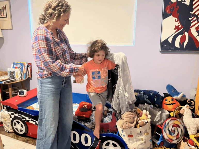 Mollie Sussman and Eli Frankel show off his new race-car bed. The 5-year-old is one of 3.6 million children in the U.S. in 2020 who are starting kindergarten this year.