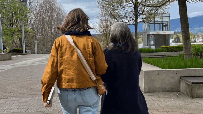 Kelly Corrigan(left) and Manoush Zomorodi(right) on a walk around Vancouver. Corrigan has her notebook in hand.