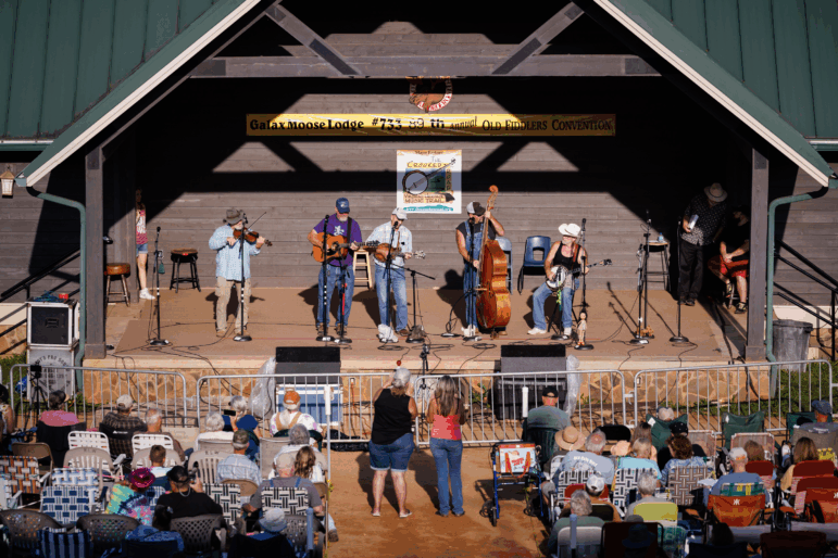 A band competes against more than 100 others in the Bluegrass band competition during the 89th Annual Old Fiddler's Convention on Saturday, Aug. 9, 2025, at Felts Park in Galax, Va.