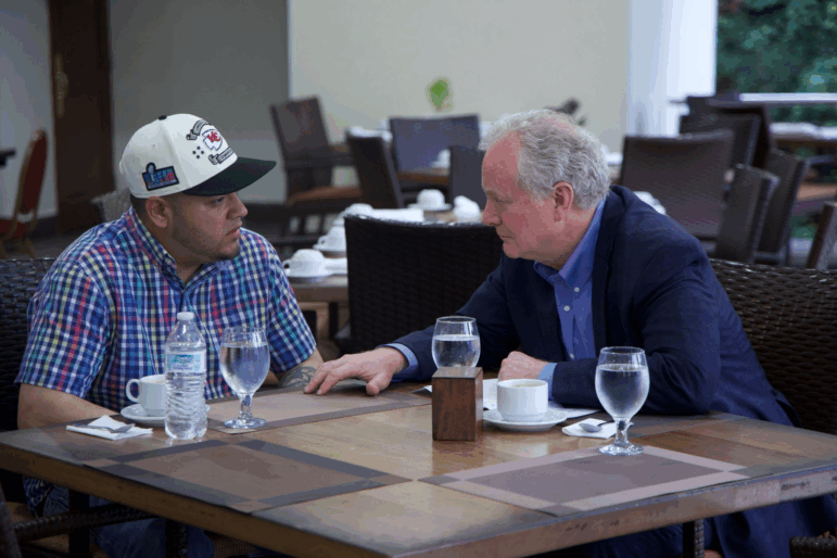Senator Chris Van Hollen, right, sits with Kilmar Abrego Garcia — the Salvadorian citizen deported by the Trump administration — in El Salvador on Thursday