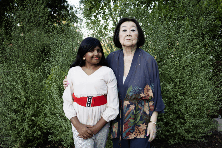 Ameya Desai poses with Linda Horikawa, an 85-year-old grandmother who is the subject of this year's winning middle school entry in NPR's Student Podcast Challenge.
