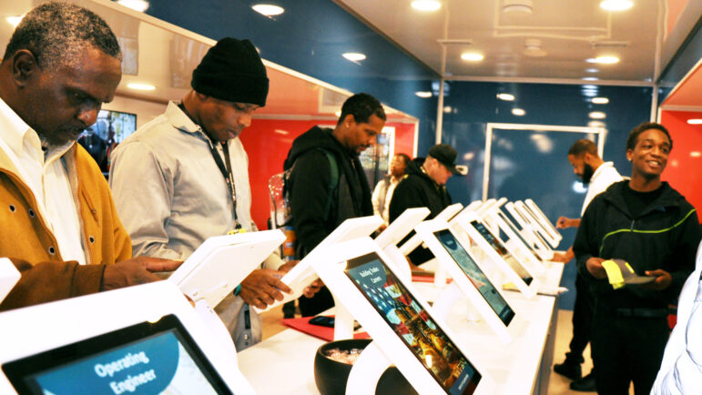 Resource fair attendees explore careers inside The Alabama Experience mobile career expo.