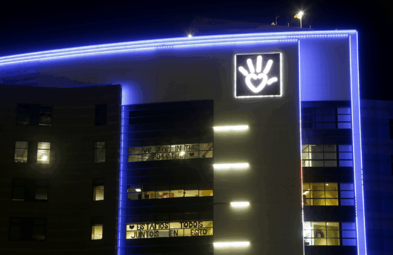 Phoenix Children's Hospital is shown at night with blue light outlining it.