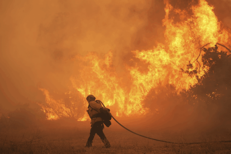 A firefighter battles the Canyon Fire in August in Hasley Canyon, Calif. As temperatures rise with human-caused climate change, wildfire risk is getting worse.