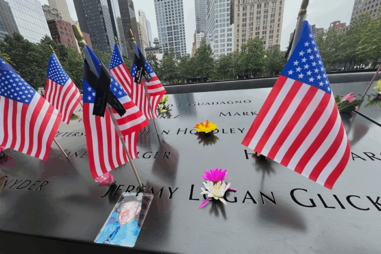 Flags and flowers are placed in the inscribed names at the National September 11 Memorial in New York on Wednesday, Sept. 10, 2025.