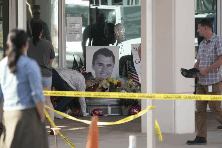 Well-wishers pay their respects to Charlie Kirk at a makeshift memorial at the national headquarters of Turning Point USA in Phoenix, Ariz., on Wednesday.