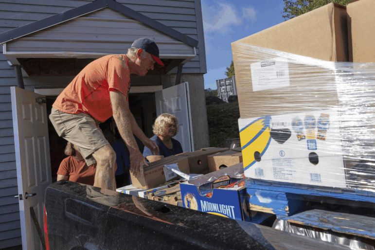 Neighbors Cupboard volunteers Mike Masnyk and Ellie Jordan unload the morning delivery of produce in Winterport, Maine, on Tuesday, Aug. 26, 2025.