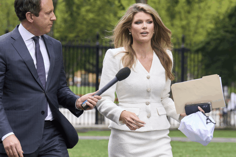 FILE - Lindsey Halligan, special assistant to the president, speaks with a reporter outside of the White House, Wednesday, Aug. 20, 2025, in Washington.
