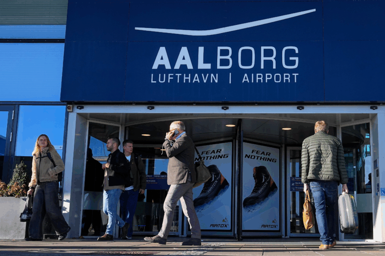 People walk outside Aalborg Airport in Denmark on Thursday, Sept. 25, 2025, after drones were observed on the airport on Wednesday evening and the night to Thursday, and the airspace over the airport was closed.