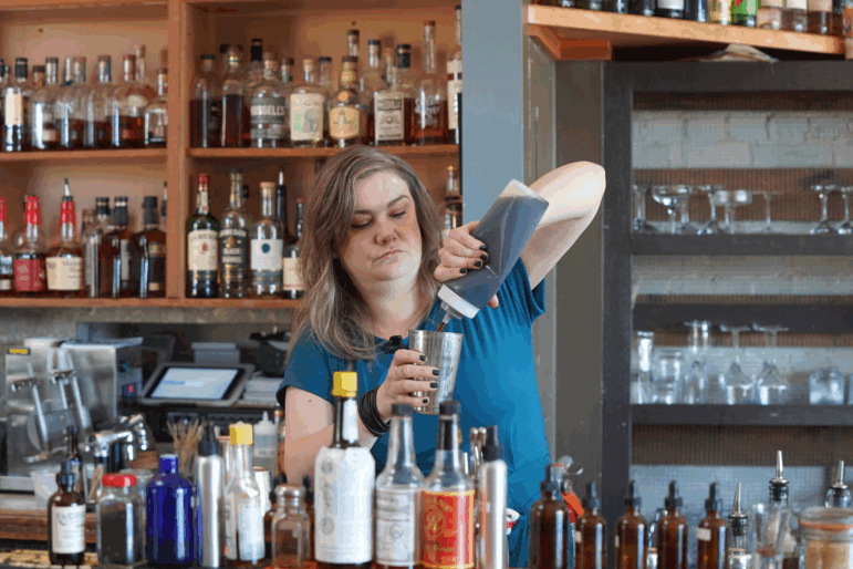 Kala Brooks is the bar manager of Top of the Monk, a craft cocktail bar in downtown Asheville. She hopes fall tourists will help boost business.