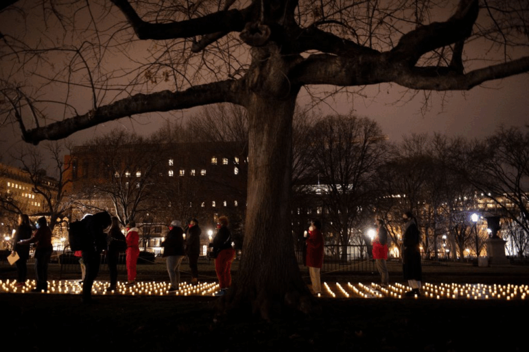 Activists gather during a vigil in Washington D.C. for nurses who died during the COVID-19 pandemic on January 13, 2022. In 2021, more than 460,000 people died of COVID in the U.S. but last year it was around 47,000.