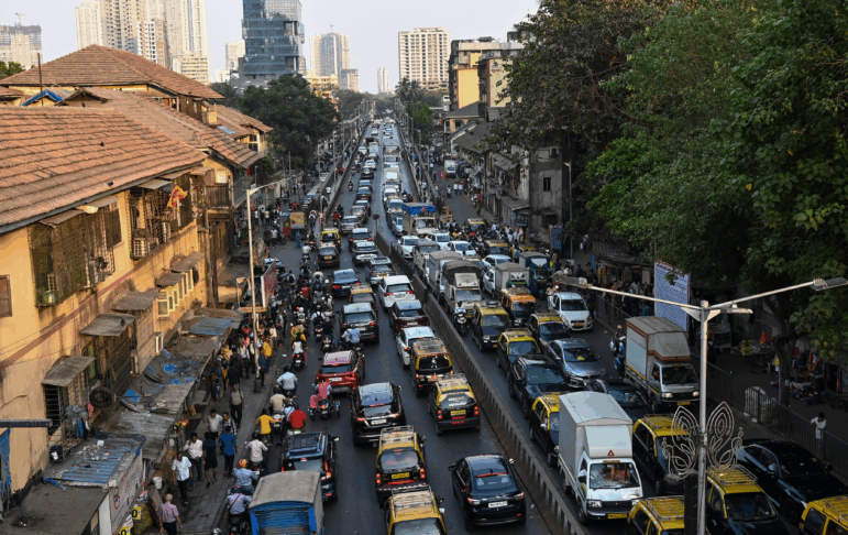 Lanes of traffic are packed with vehicles on a bridge in India.