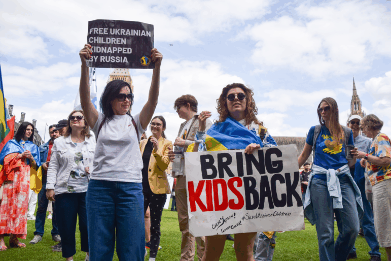 Protesters hold placards during a demonstration in Parliament Square in London, demanding the release of Ukrainian children kidnapped by Russia and an end to Russian aggression in Ukraine. The Ukrainian government has insisted that the return of children from Russia be part of any peace deal with the country.