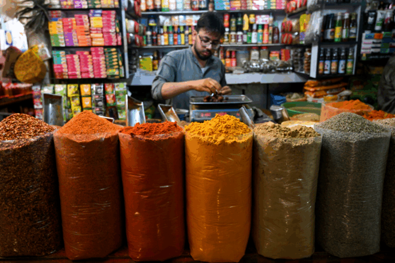 A shopkeeper sells spices at a market in Karachi on June 10, 2025.