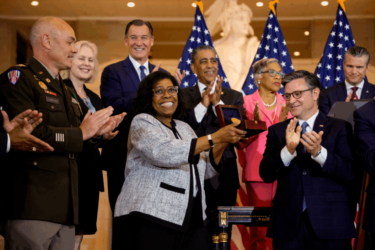 House Speaker Mike Johnson, R-La., presents Debra Willett, the granddaughter of Harlem Hellfighter Sgt. Leander Willett, with the Congressional Gold Medal on behalf of all of the "Harlem Hellfighters" of World War I during a ceremony on Capitol Hill on Wednesday in Washington, D.C.