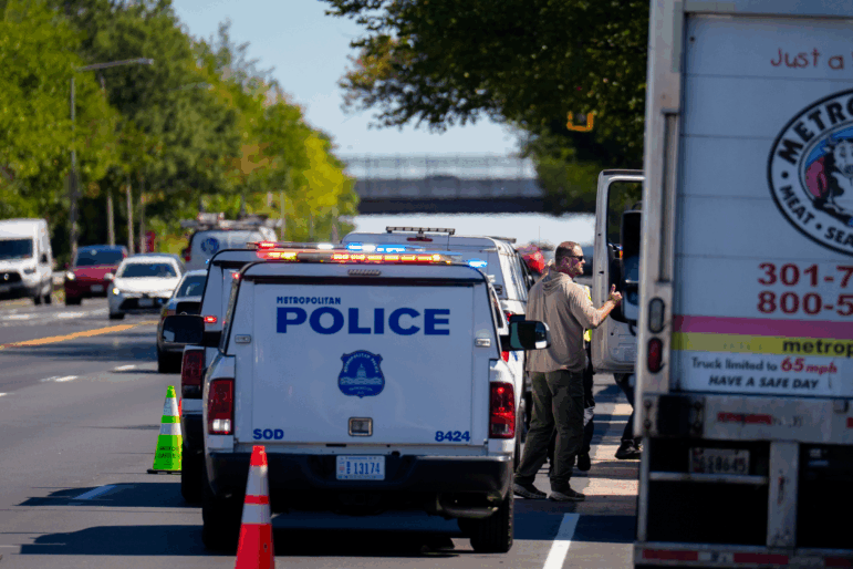 Law enforcement officers with the Department of Homeland Security and the Metropolitan Police Department set up a traffic safety checkpoint along a busy Washington, D.C., street on Monday.