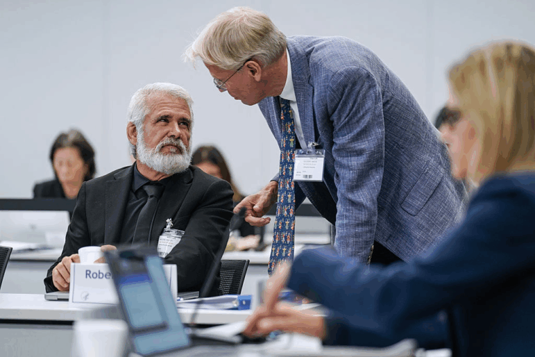 Martin Kulldorff (right) speaks with Robert Malone during a meeting of the CDC's Advisory Committee on Immunization Practices on September 18, 2025 in Chamblee, Ga.
