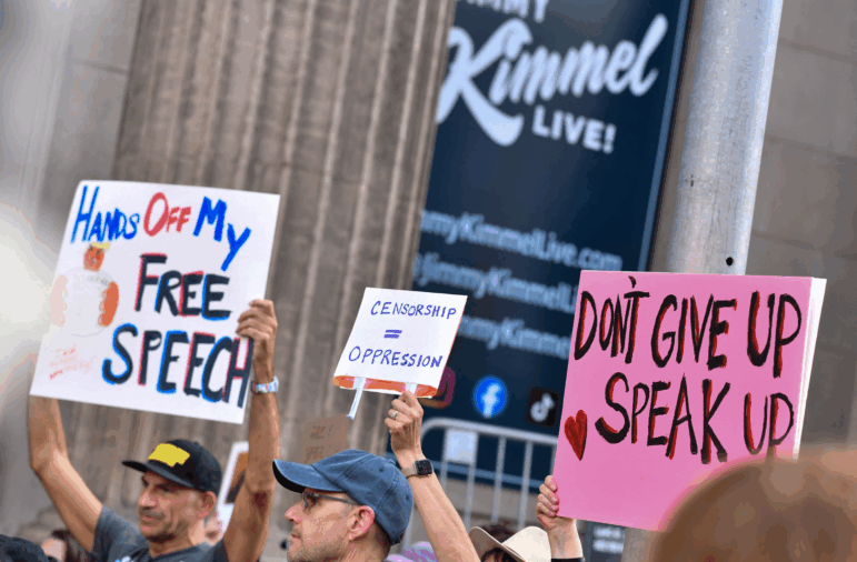 Demonstrators hold signs as they rally to protest the suspension of the "Jimmy Kimmel Live!" show outside the studio from where the show is broadcast in California on Sept. 18, 2025. Kimmel's late-night show was pulled from the air on September 17 hours after the U.S. government threatened to cancel broadcasting licenses because of comments the host made about the killing of conservative influencer Charlie Kirk.