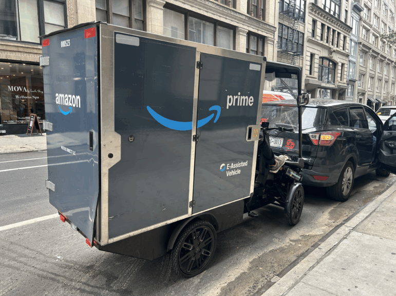 An Amazon Prime delivery pedicab is parked on a Manhattan street. Amazon has agreed to settle with the U.S. government a lawsuit over its Prime membership program.