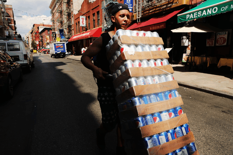 NEW YORK, NY - JULY 06: A man delivers soda on July 6, 2016 in New York City. New York City and much of the Northeast is experiencing the real heat of the summer with temperatures in the 90's. (Photo by Spencer Platt/Getty Images)