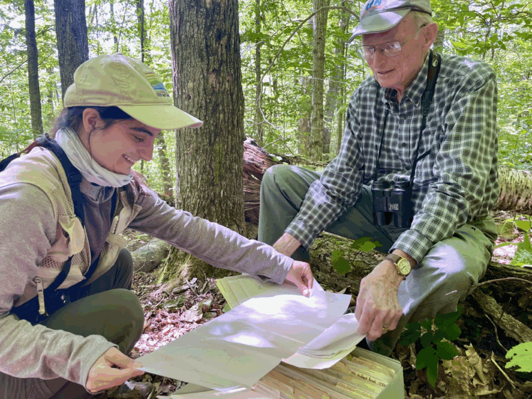 Miranda Zamarelli and Dick Holmes of Dartmouth College review one of the early paper maps used to chart songbird territories in a patch of woods in central New Hampshire.