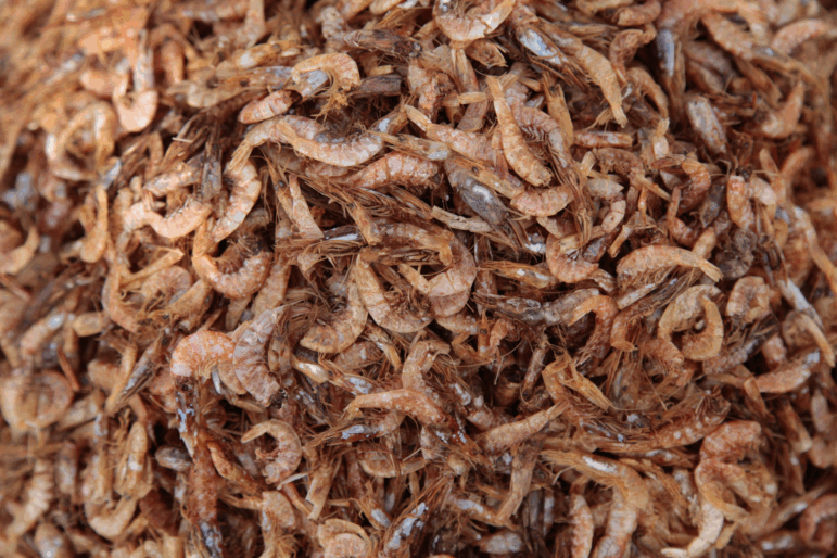 Mounds of dried shrimp sit at India's port of Visakhapatnam, where much of the economy is based around seafood exports — chiefly frozen shrimp to the U.S.