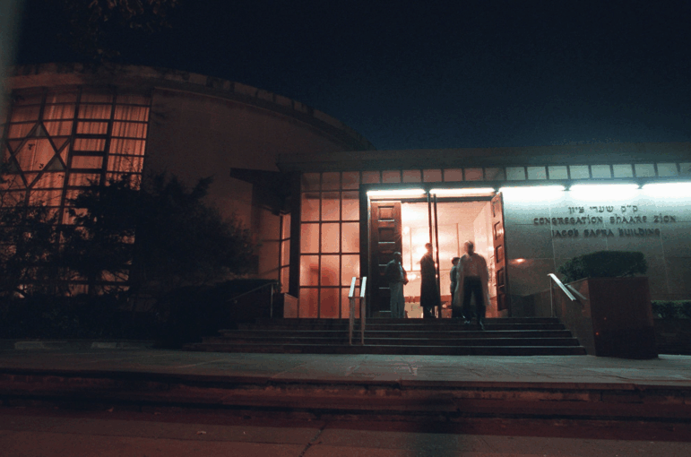 Shaare Zion (pictured in 1995) started as a small congregation in the 1940s. It is the largest Syrian synagogue in New York, and sits on a busy street in the neighborhood of Gravesend in Brooklyn.