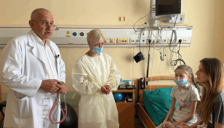 Dr. Boris Todurov, left, performed heart transplant surgery on his patient, 12-year-old Kira Skilarova, second from right, in the midst of a Russian attack on Kyiv on July 9. Kira received her heart from a 4-year-ld girl who died earlier that evening at the Ohmatdyt Hospital across the city. Also pictured are the donor's mom, second from left, and Kira's mom, far right.