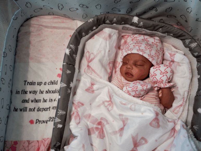Kaomi Holmes, 10 days old, sleeps in her crib at her home in Greenville, Miss. She was  was delivered by emergency cesarian section four weeks before reaching full term.