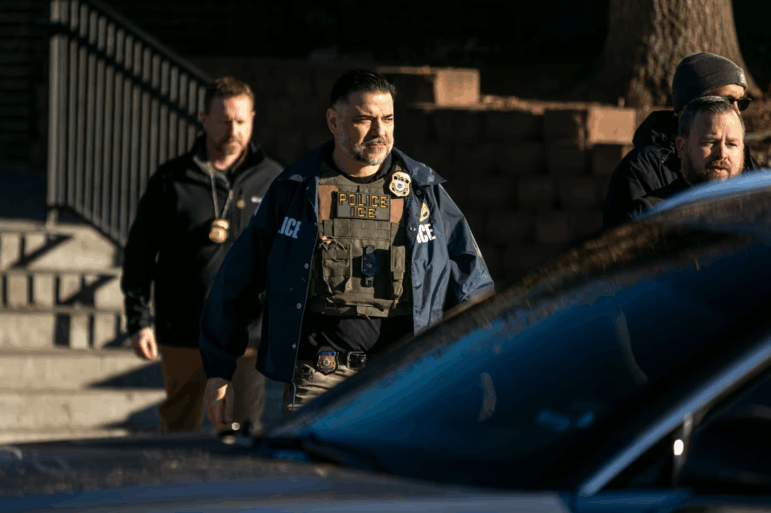 Federal law enforcement agents outside a metro Denver apartment complex during an immigration raid Feb. 5, 2025
