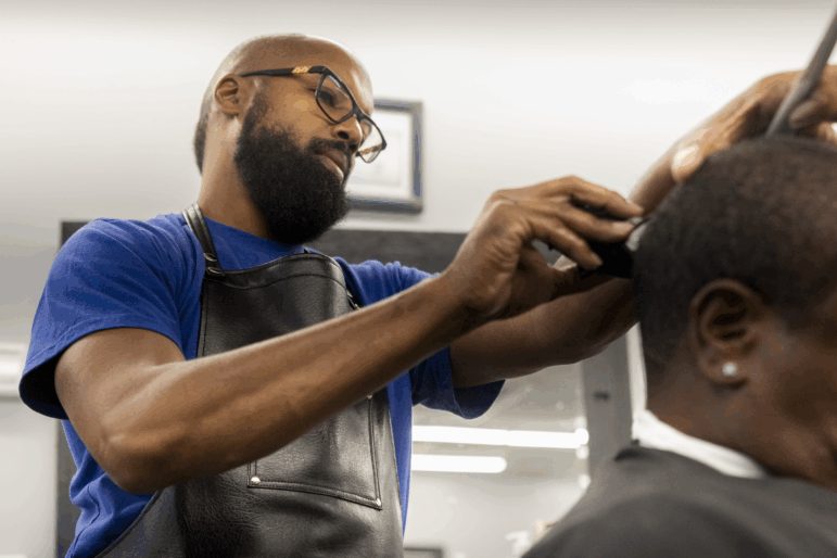 Memphis residents in the Frayser area share opinions on the presence of the United States National Guard deployment on Tuesday, September 30, 2025 Carnell Vann, Jr., 49, Vann Cut Barber Shop owner cutting client’s hair at establishment.