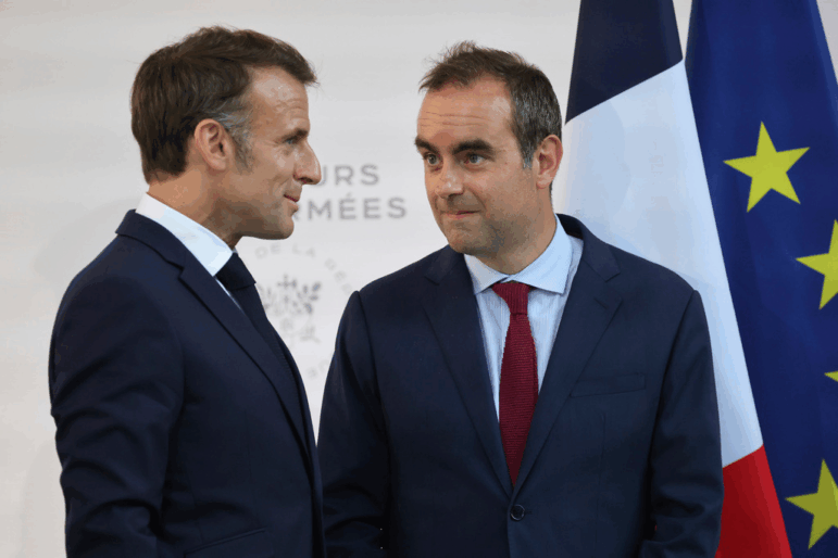 FILE - Then French Defense minister Sebastien Lecornu, right, and France's President Emmanuel Macron talk at the end of an address by the president to army leaders in Paris Sunday July 13, 2025.